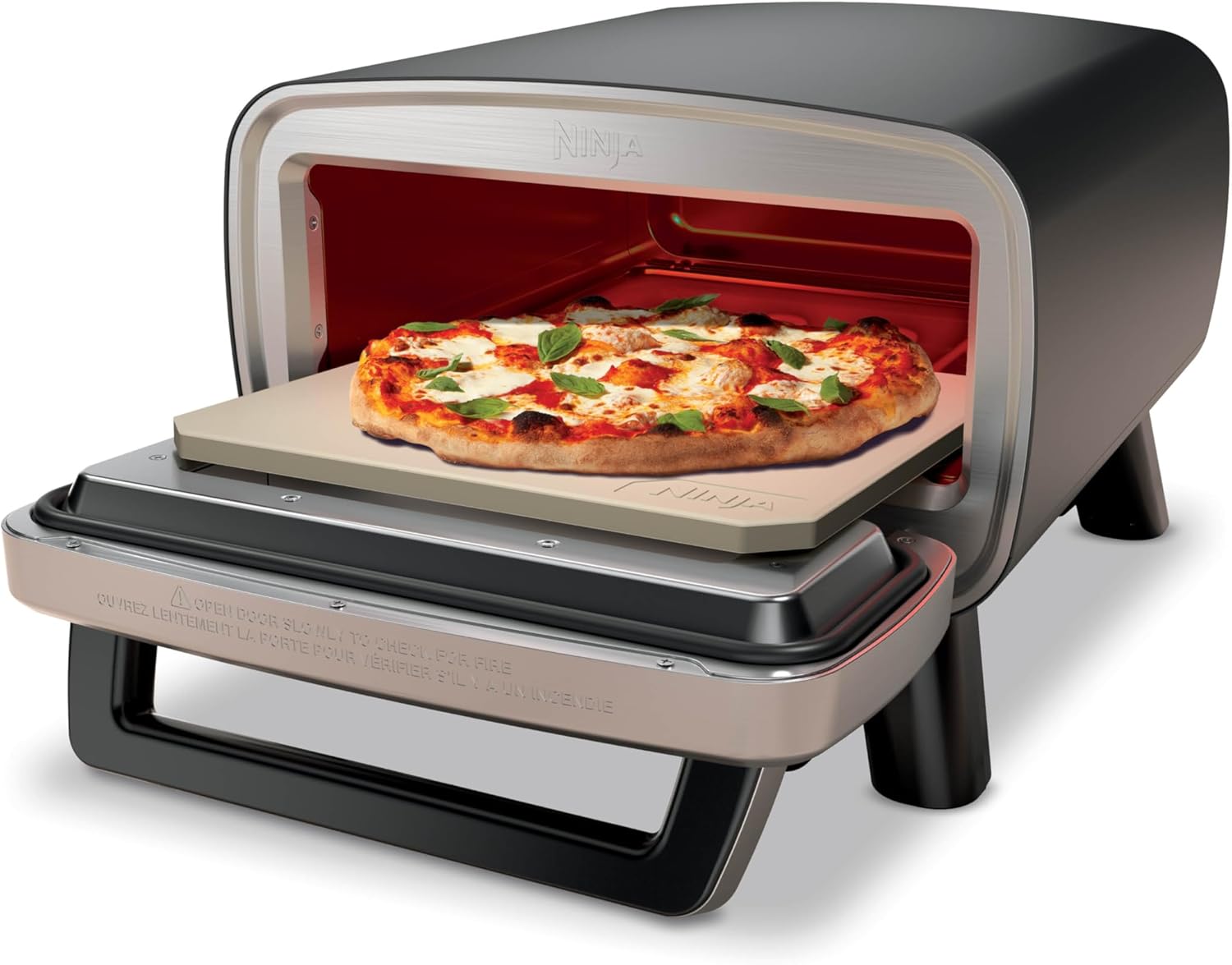 Ninja Artisan Electric Outdoor Pizza Oven in gray with pizza stone on a patio